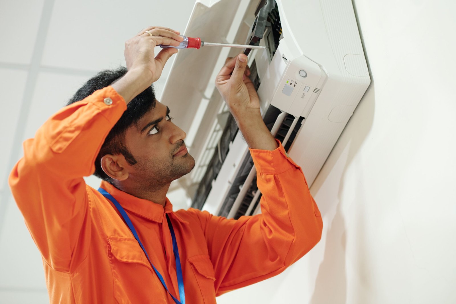 Professional technician repairing air conditioner in Dubai home